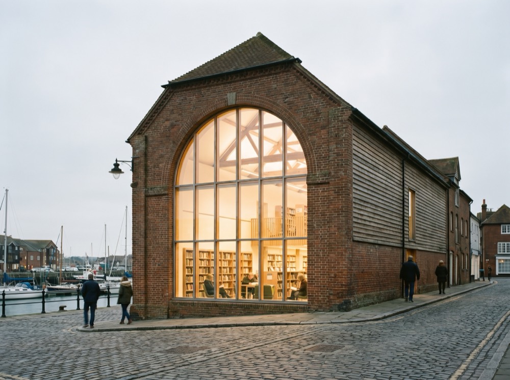 A brick granary library with a lit arched window